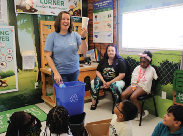 woman holding recycling can